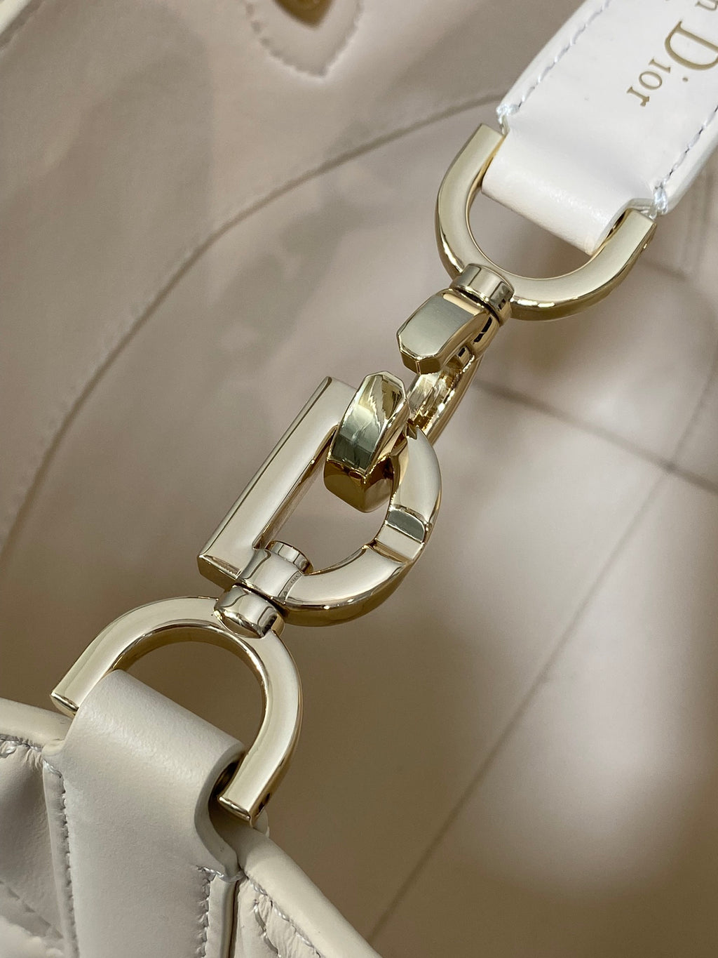 Dior cream leather bag clasp hardware with gold-tone rings and hooks