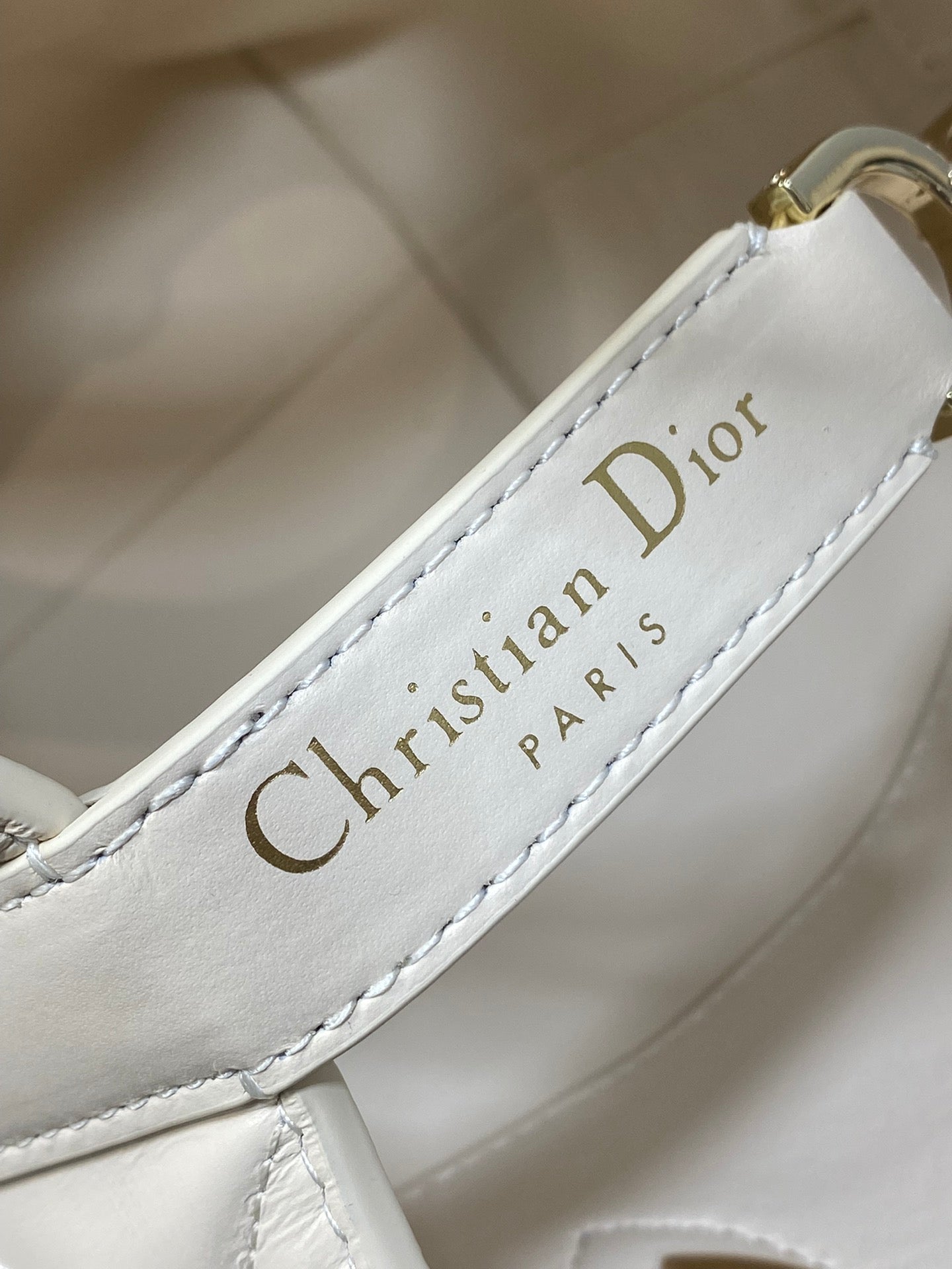 Dior cream leather label inside handbag reading “Christian Dior PARIS”