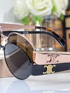Sunglasses close-up, tortoiseshell temples, gold emblem detail, dark lenses