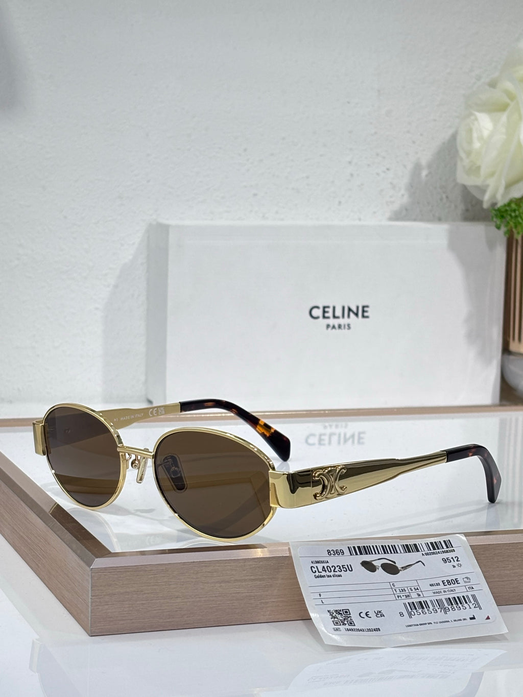 Round sunglasses, gold frame, brown lenses, black temple arms