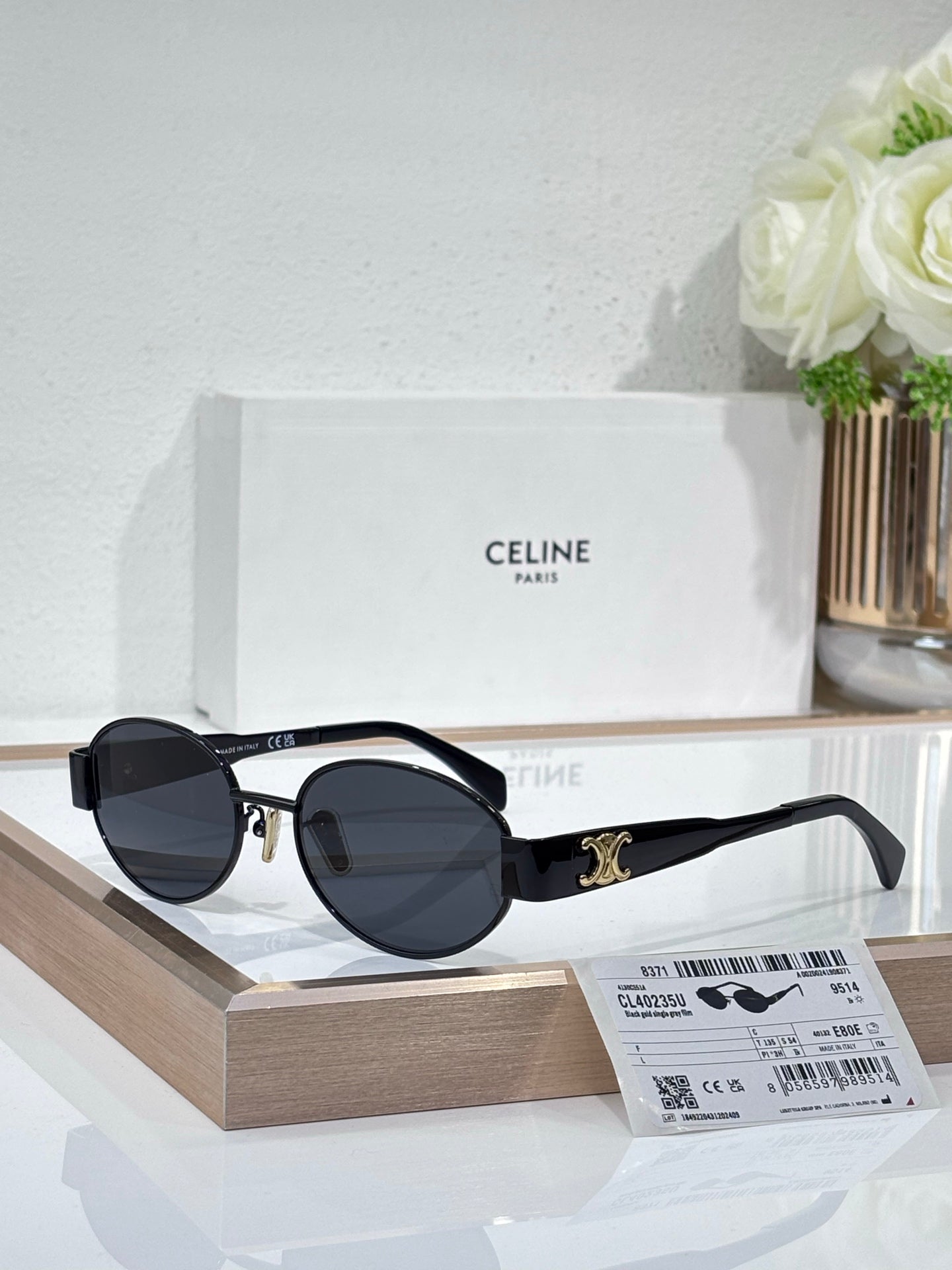 Round sunglasses, silver frame, dark blue lenses, black temple arms