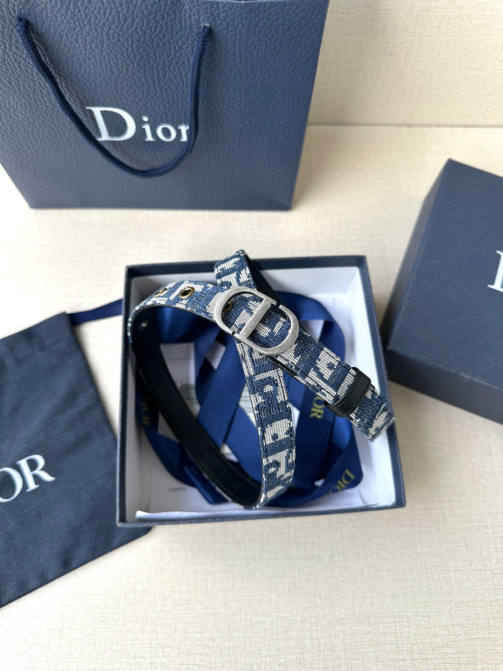 Dior belt in gift box with blue monogram strap and silver CD buckle.