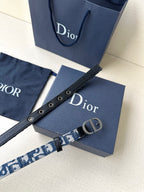Dior belt angled view with blue monogram strap, eyelets, and silver CD buckle.