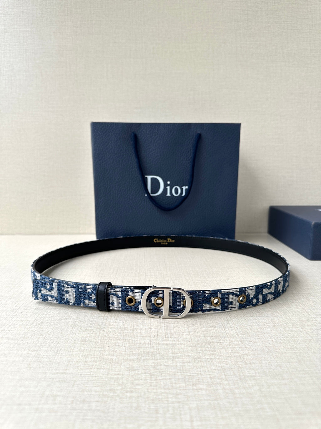 Blue Dior belt with patterned strap, black edge, silver buckle