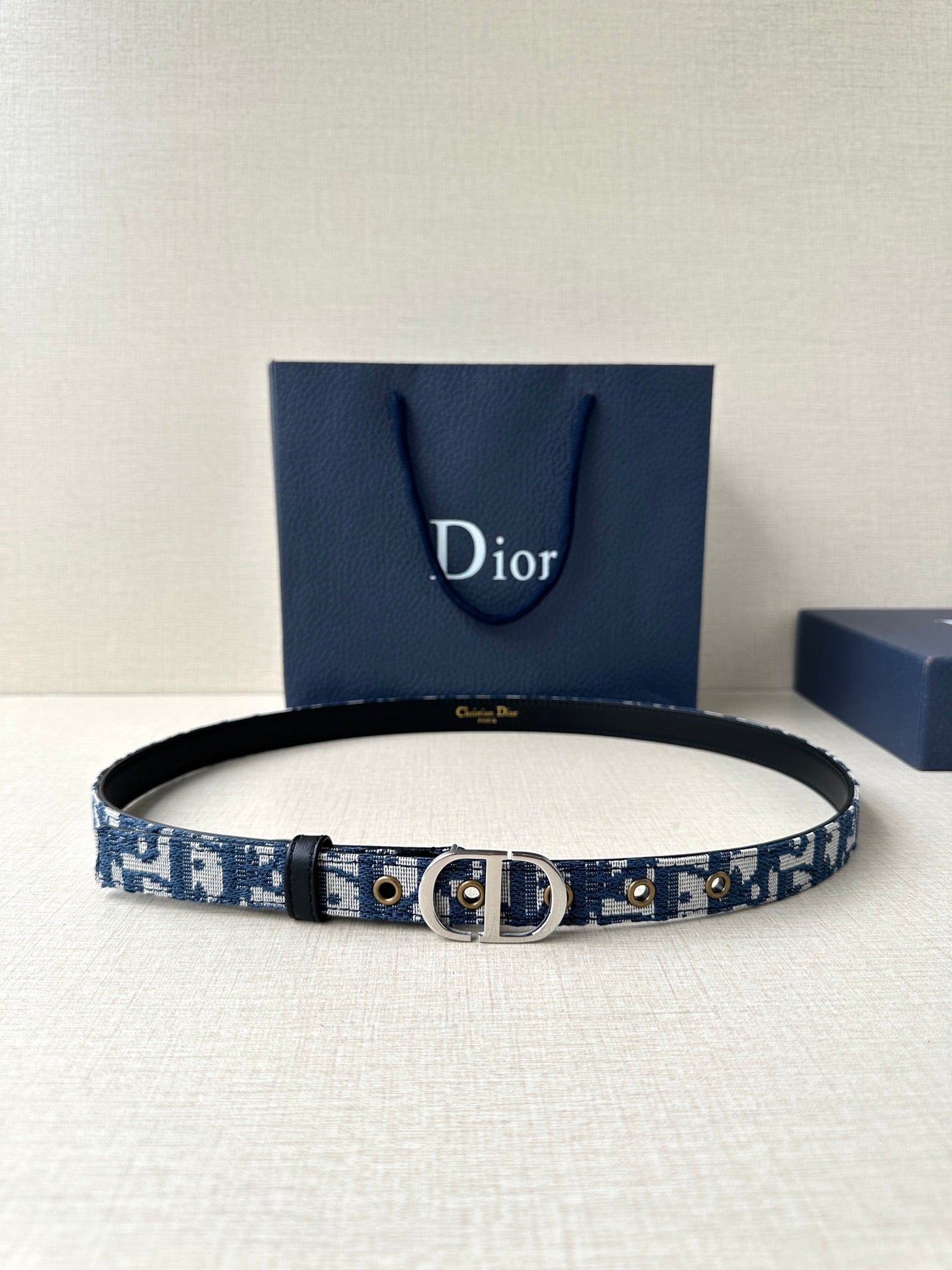 Blue Dior belt with patterned strap, black edge, silver buckle