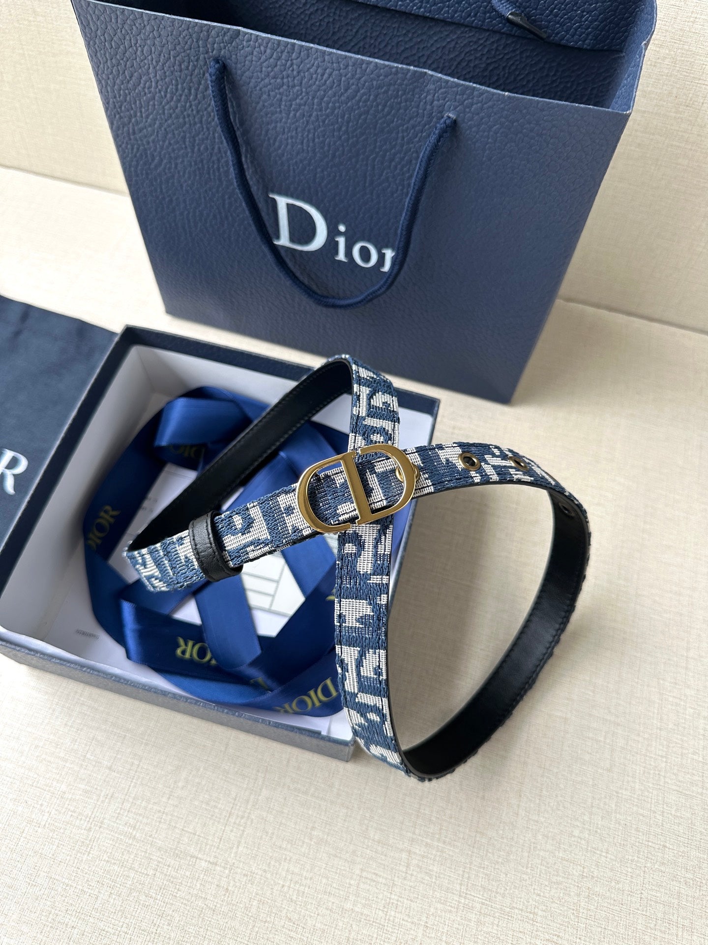 Dior belt in box: blue monogram strap, gold CD buckle and black leather ends