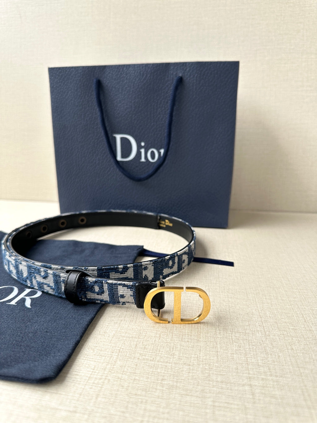 Dior belt with blue patterned strap, gold CD buckle and matching fabric pouch