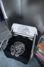 Folded black and white T-shirts with rhinestone elephant emblem