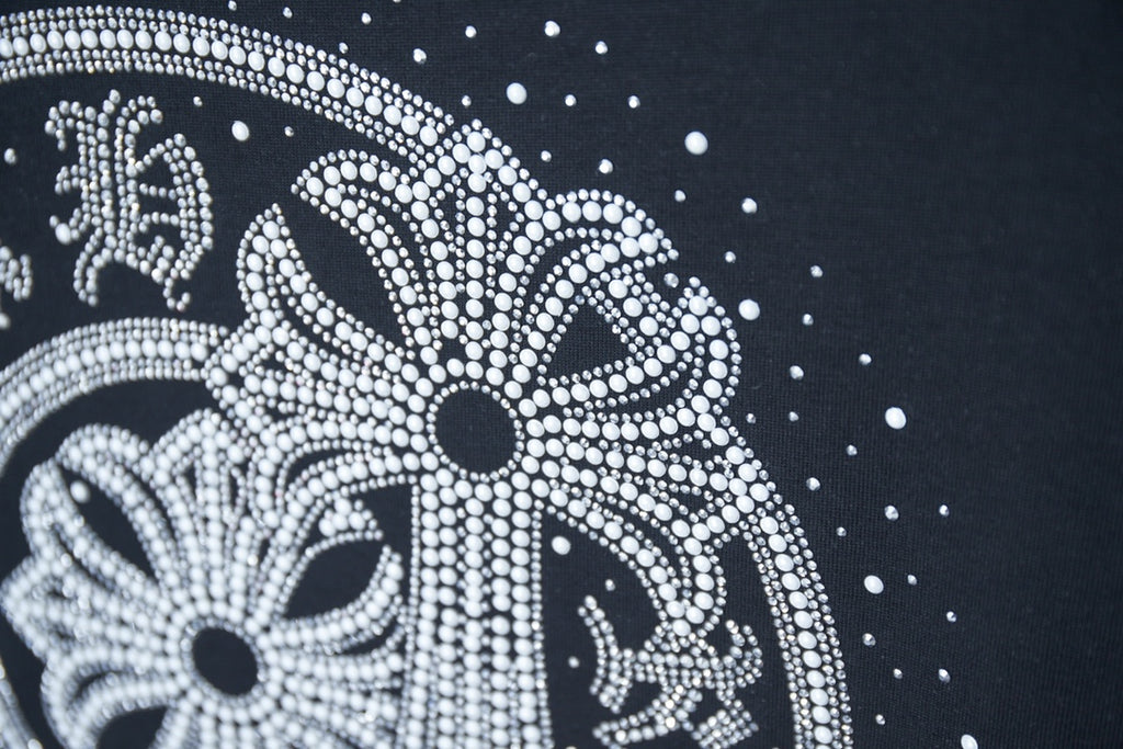 Close-up of circular rhinestone elephant graphic on dark navy T-shirt