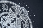 Close-up of circular rhinestone elephant graphic on dark navy T-shirt