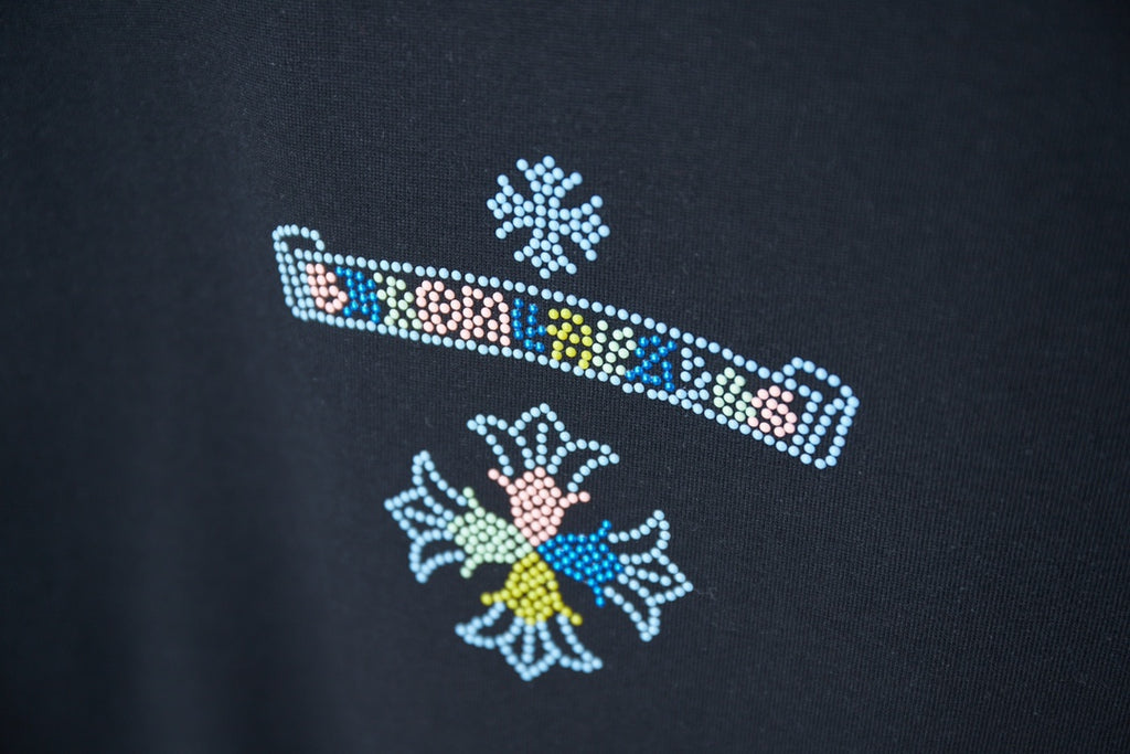 Black T-shirt with colorful rhinestone stripe and flower-like motifs