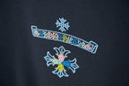 Black T-shirt with colorful rhinestone stripe and flower-like motifs