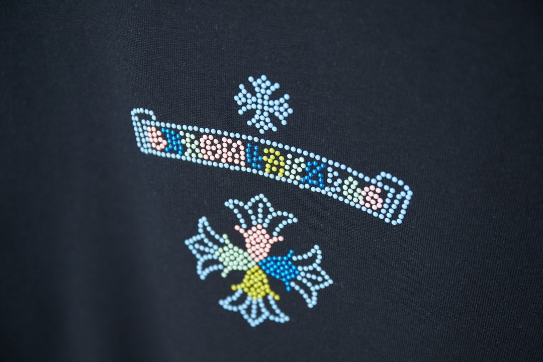 Black T-shirt with colorful rhinestone stripe and flower-like motifs