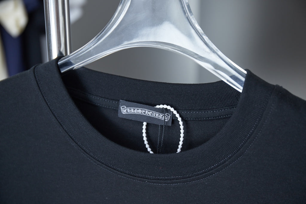Black T-shirt neckline with beaded trim and inner neck label
