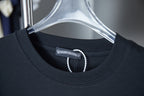 Black T-shirt neckline with beaded trim and inner neck label