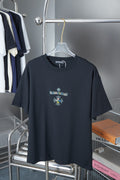 Black crew-neck T-shirt with small rhinestone logo on chest