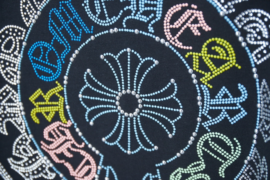 Black T-shirt close-up: rhinestone circular pattern with multicolor accents