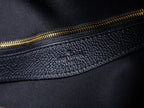 Louis Vuitton bag side zipper, gold tone teeth on textured dark leather