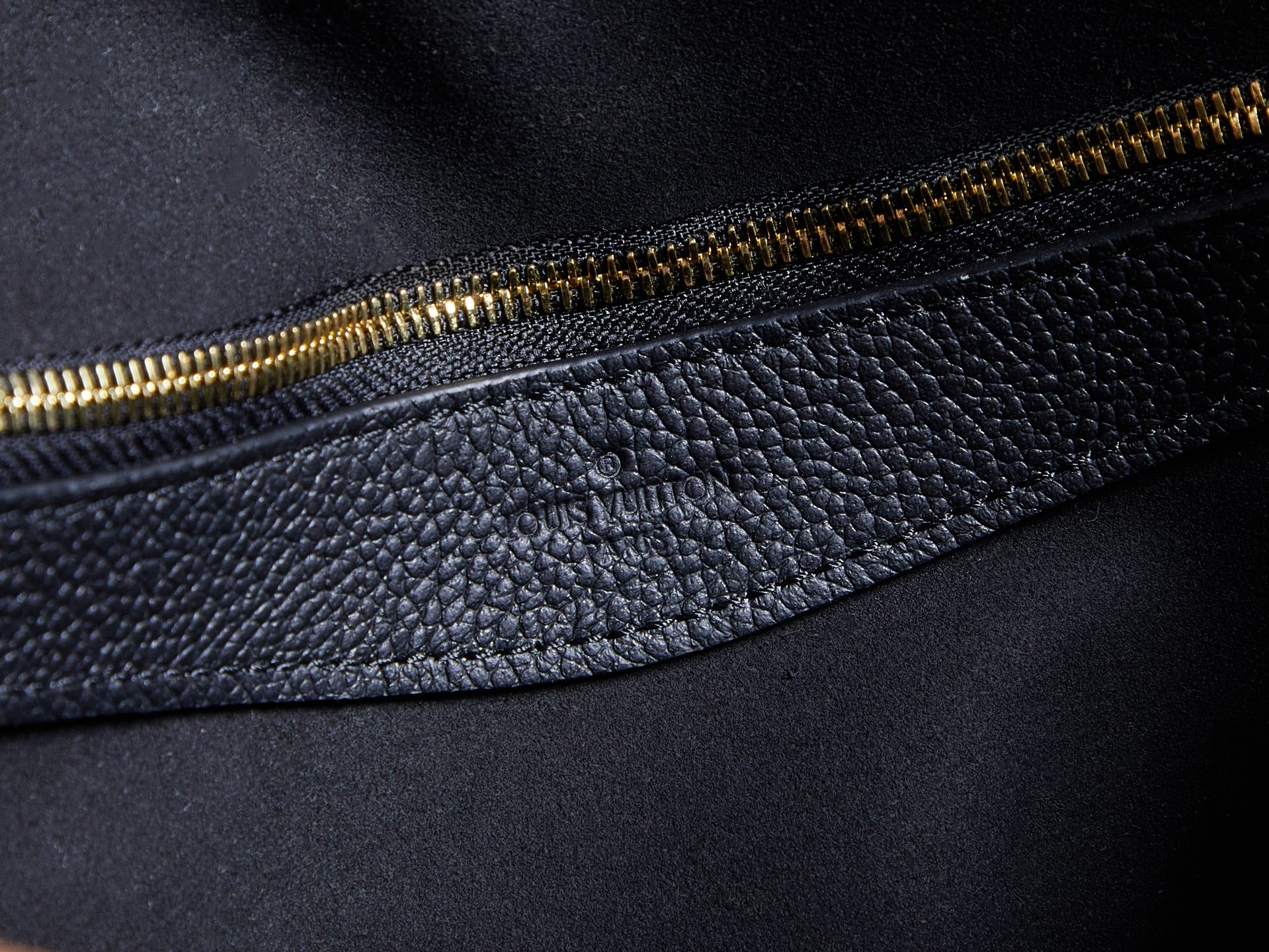 Louis Vuitton bag side zipper, gold tone teeth on textured dark leather