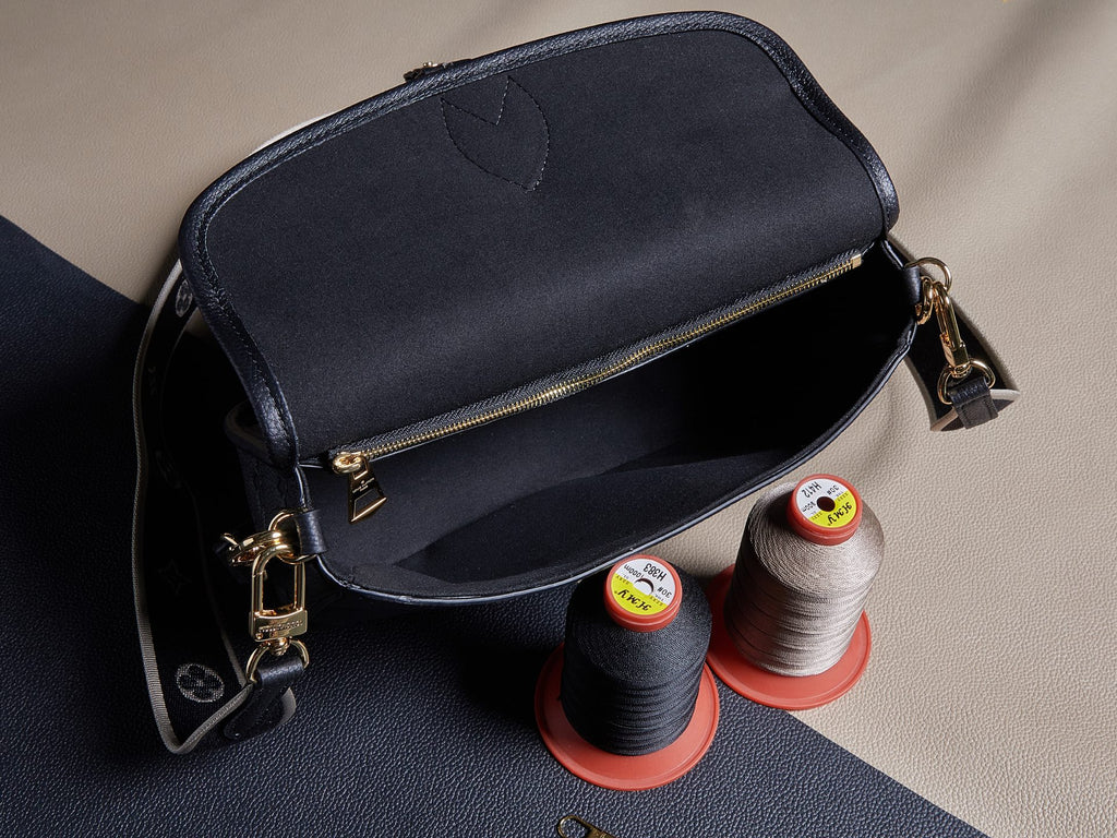 Louis Vuitton crossbody bag, gold zipper and shoulder straps, textured dark leather