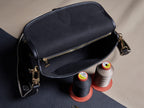 Louis Vuitton crossbody bag, gold zipper and shoulder straps, textured dark leather