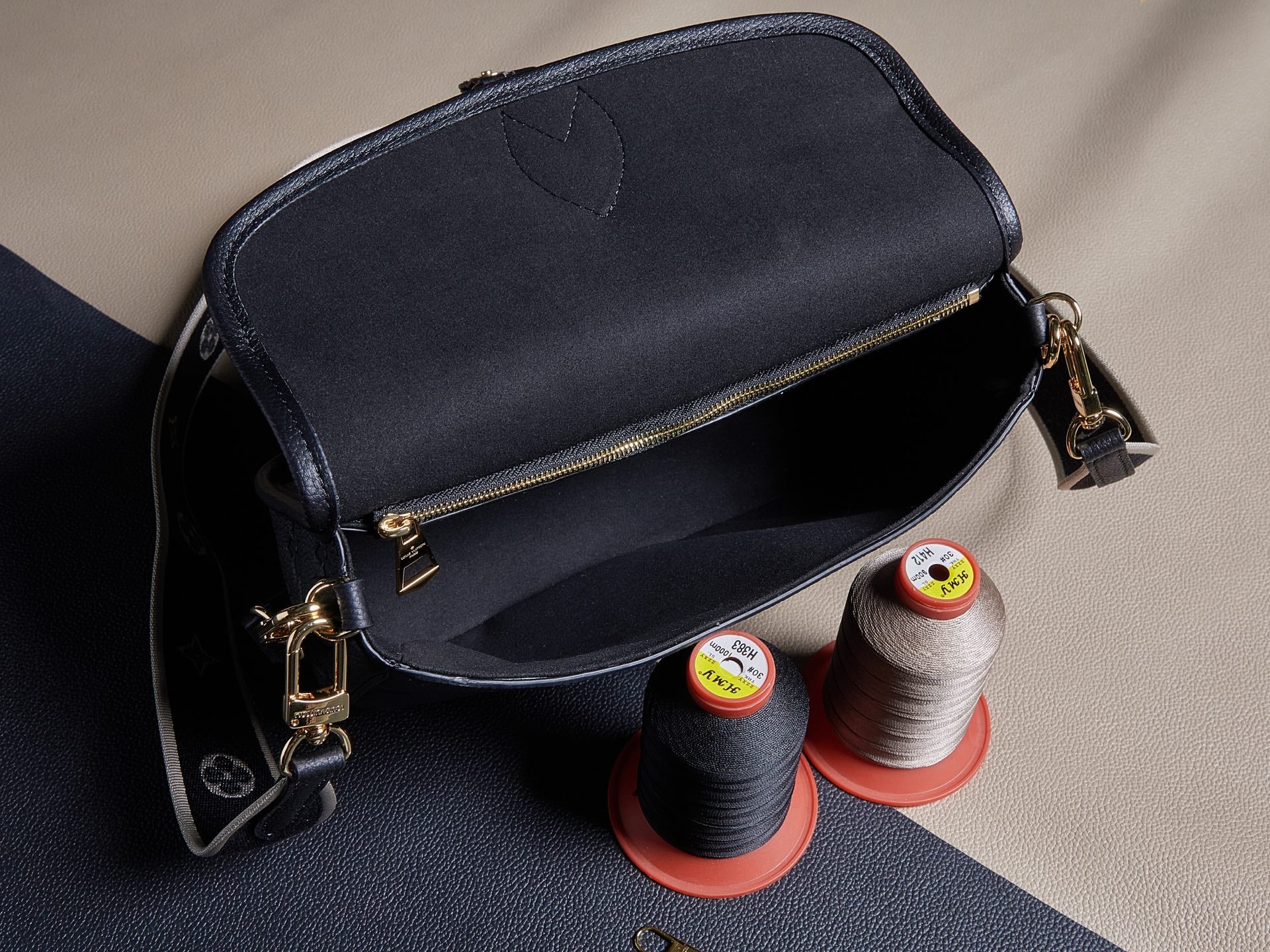 Louis Vuitton crossbody bag, gold zipper and shoulder straps, textured dark leather