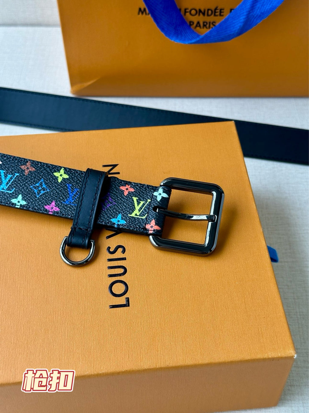 Louis Vuitton belt close-up with multicolor monogram strap and gold-toned buckle