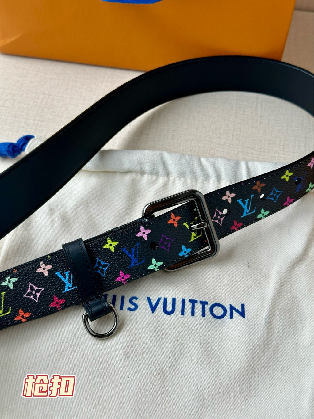 Louis Vuitton belt close-up with multicolor monogram strap and silver square buckle