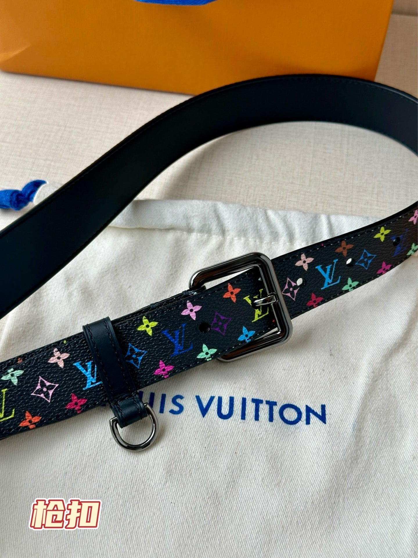 Louis Vuitton belt close-up with multicolor monogram strap and silver square buckle