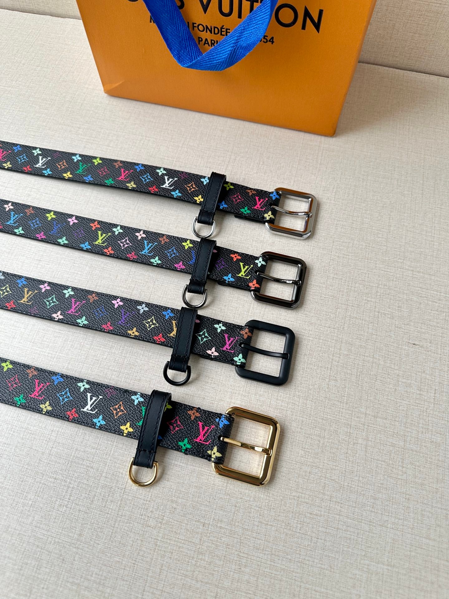Louis Vuitton belts with multicolor monogram straps and mixed buckle finishes