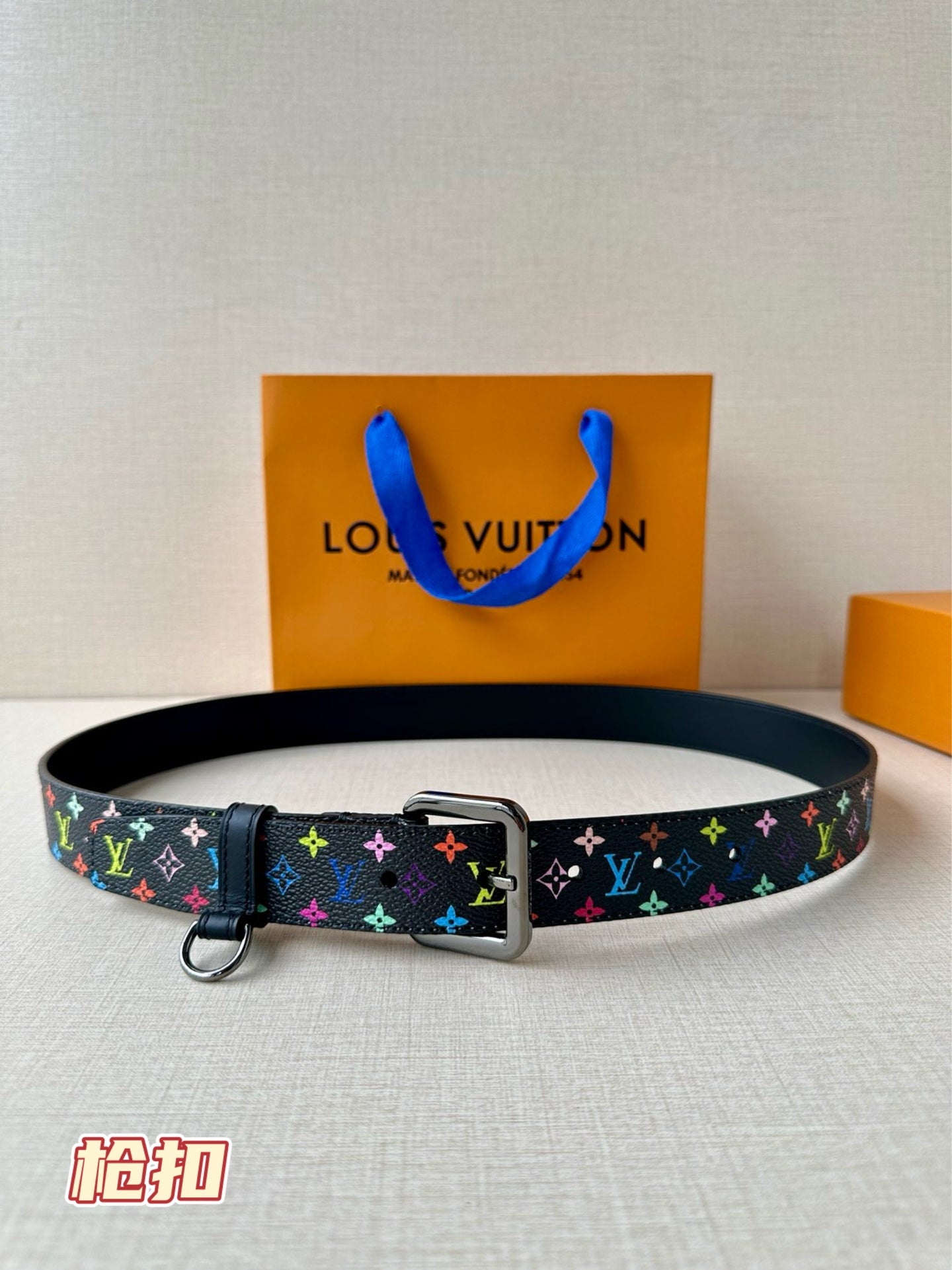 Louis Vuitton belt with multicolor monogram strap and silver buckle on dark base
