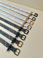 Louis Vuitton belts in a row with multicolor monogram straps and assorted buckle colors