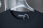 Dark blue T-shirt collar close-up with brand label and neckline stitching