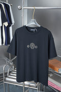 Dark blue T-shirt on hanger, crew neck, rhinestone-style emblem graphic on chest