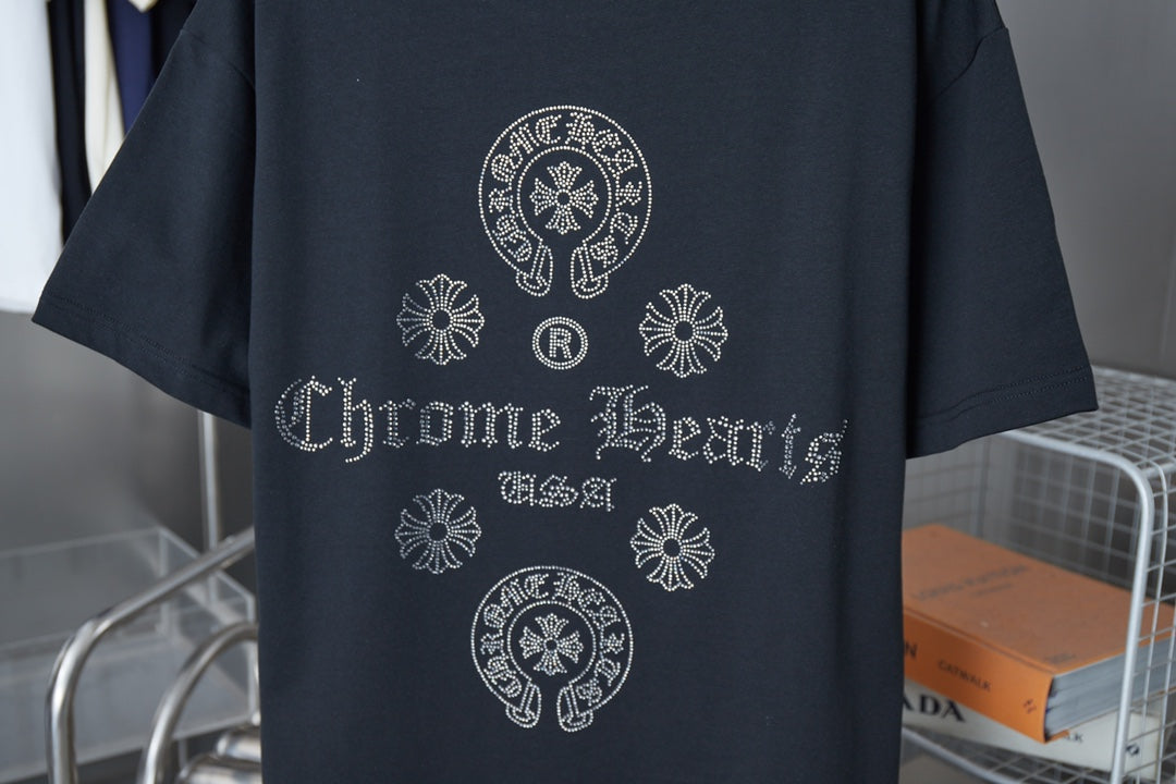 Dark blue T-shirt front with rhinestone-style crest, flowers, and 'Chrome Hearts' text