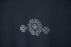 Dark blue T-shirt chest emblem with rhinestone-style circular logo and floral motifs