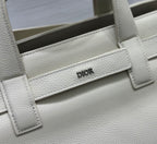 Dior handbag front panel with “DIOR” logo, textured leather and buckle detail
