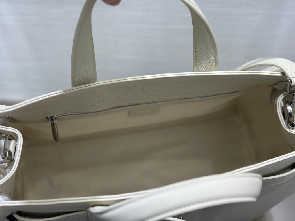 White Dior handbag interior opening with zip top and side seam stitching