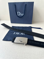 Dior belt with dark strap and silver rectangular buckle plate with Dior emblem