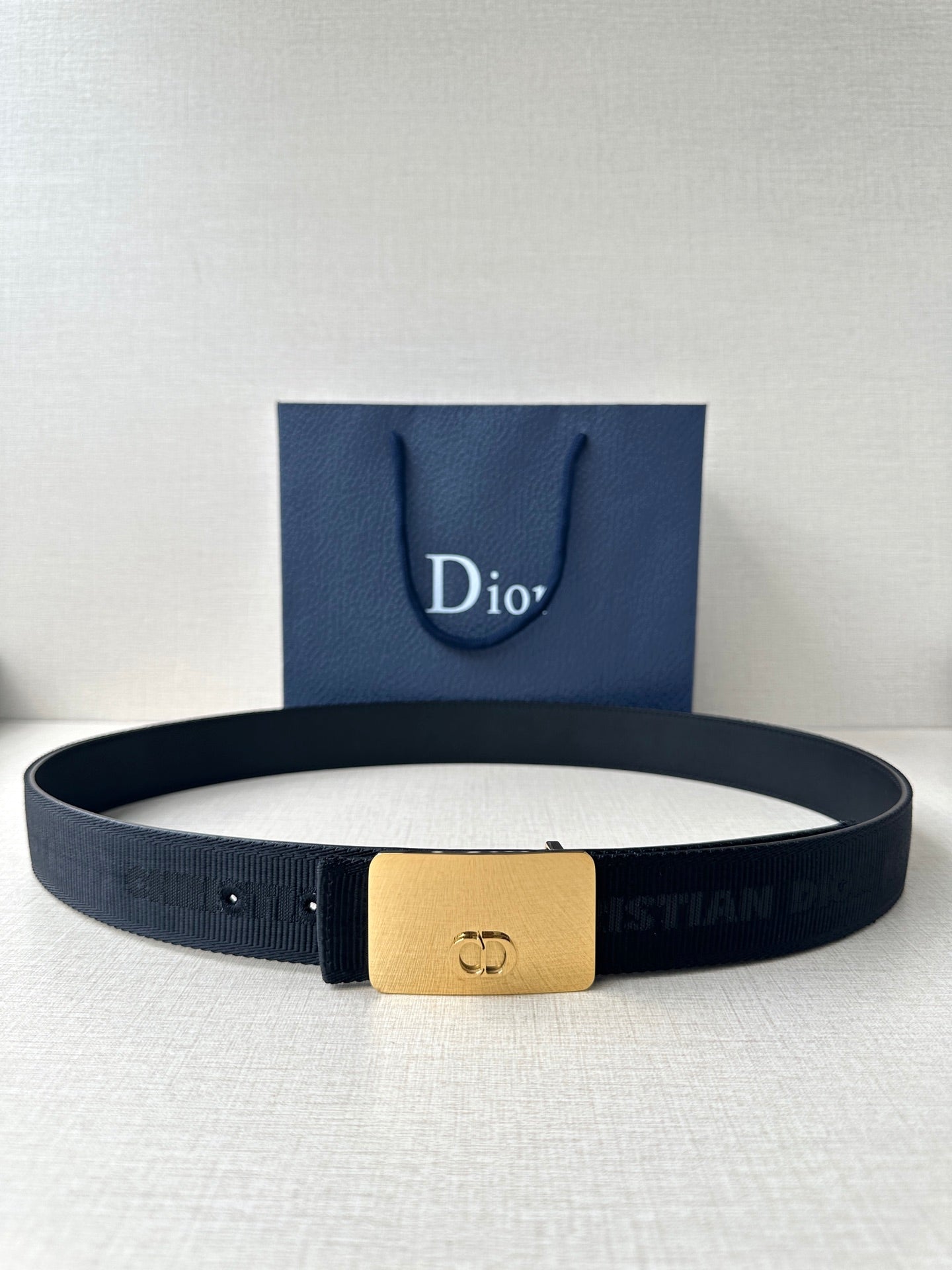 Dior logo belt with dark textured strap and gold rectangular buckle