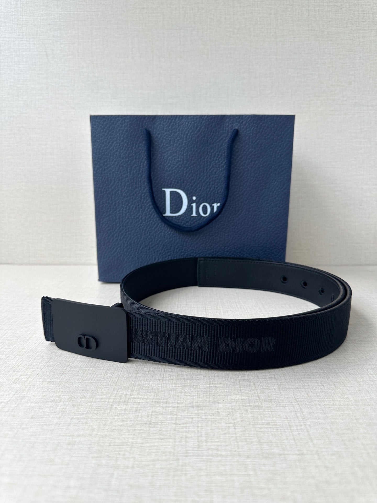 Dior belt with dark blue strap and matte rectangular buckle