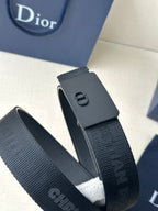 Dior belt with dark blue strap showing embossed Dior pattern and buckle