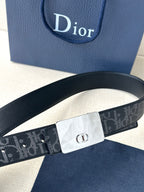 Designer belt with dark patterned strap and silver-tone square buckle
