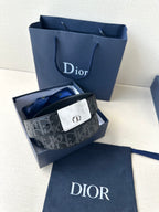 Designer belt with patterned dark strap and silver-tone clasp buckle