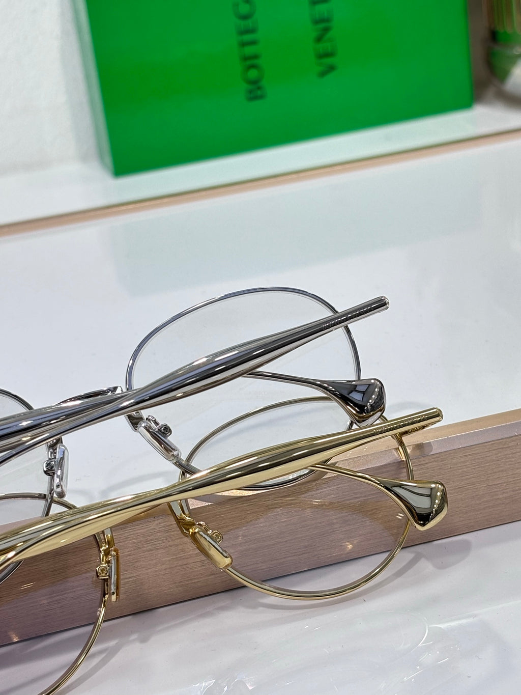 Bottega Veneta round eyeglass frames: silver and gold-tone with clear lenses, metal arms