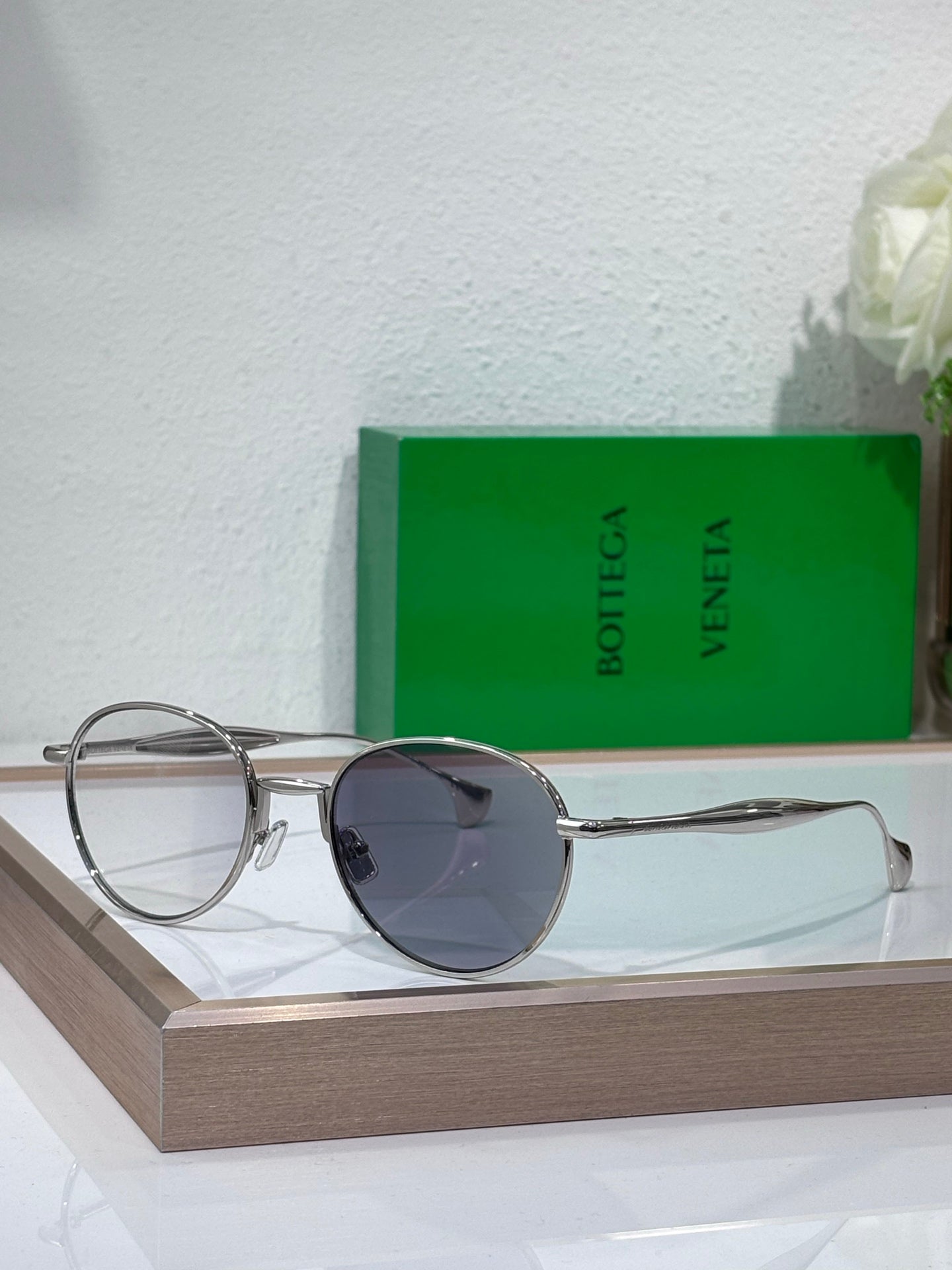 Bottega Veneta round sunglasses with dark lenses and gold-tone metal frame, slim temples