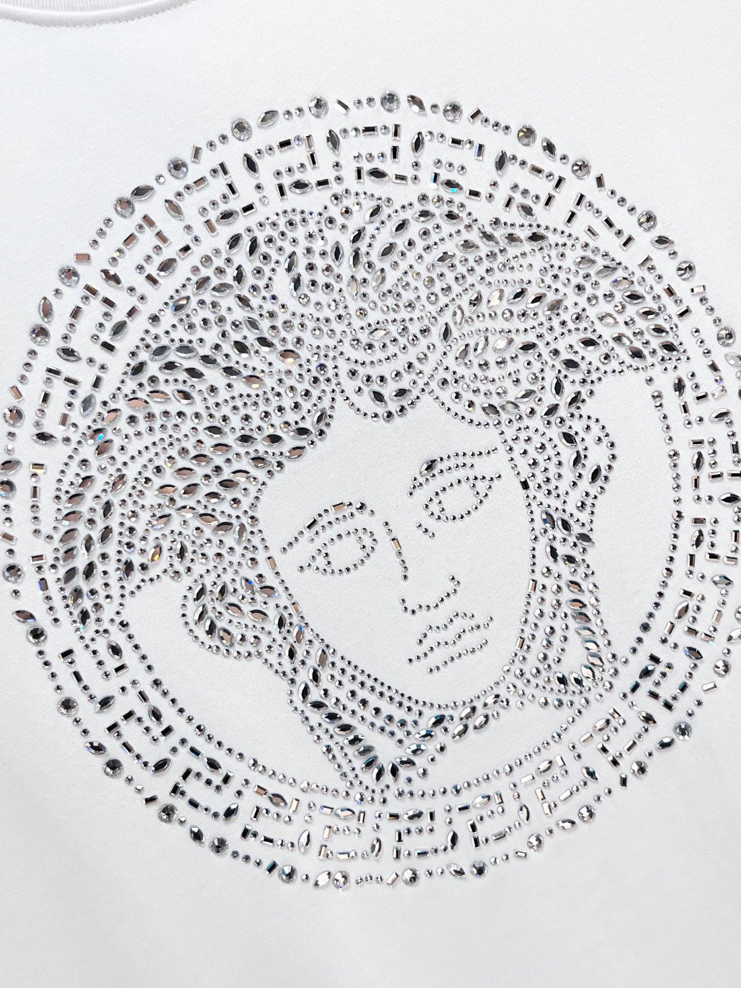 Versace white T-shirt close-up of rhinestone Medusa face graphic