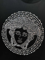 Black T-shirt with rhinestone Medusa face graphic centered on the chest