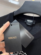 Black Versace T-shirt with VERSACE hang tags near the crew neckline