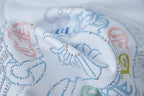 Close-up of blue and multicolor beaded graphic on white T-shirt